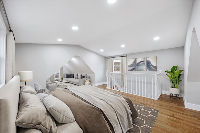 bedroom featuring baseboards, vaulted ceiling, wood finished floors, and recessed lighting