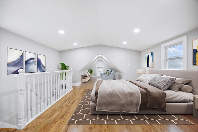 bedroom featuring vaulted ceiling, wood finished floors, and recessed lighting