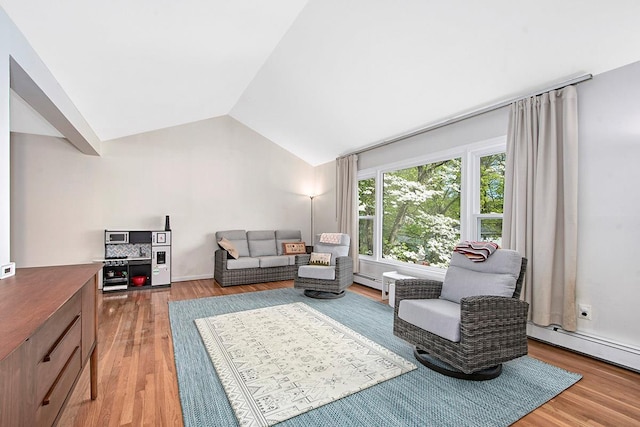 living area featuring a baseboard heating unit, lofted ceiling, and light wood-style floors