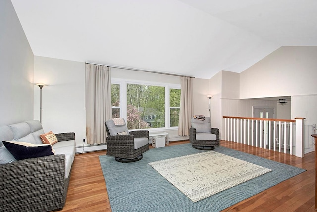 living area with a baseboard radiator, vaulted ceiling, and wood finished floors