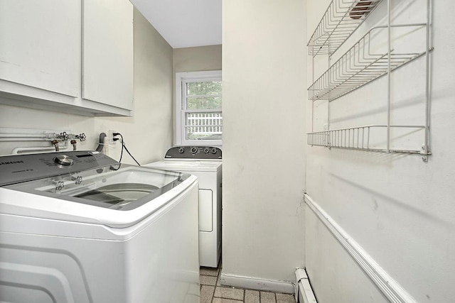laundry area with separate washer and dryer and cabinet space
