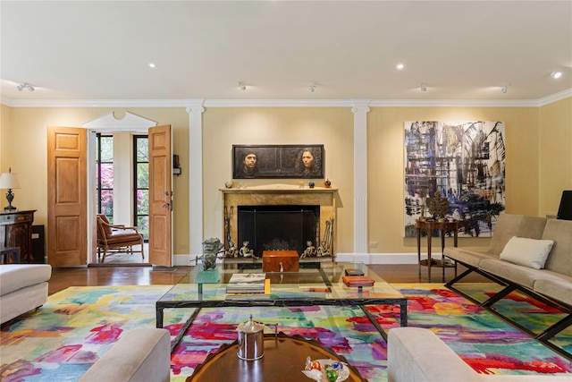 living area featuring a fireplace, wood finished floors, baseboards, ornamental molding, and recessed lighting