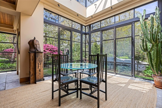 sunroom / solarium with french doors, outdoor dining space, and a skylight