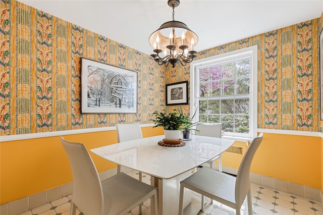 dining area with tile patterned floors, a wealth of natural light, wallpapered walls, and a notable chandelier