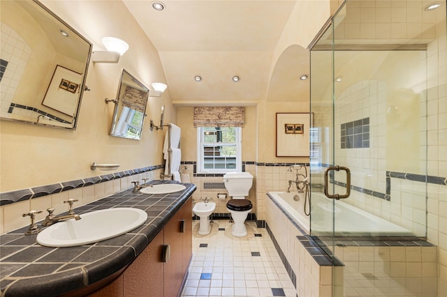 bathroom with a sink, tile walls, tile patterned flooring, and a bidet