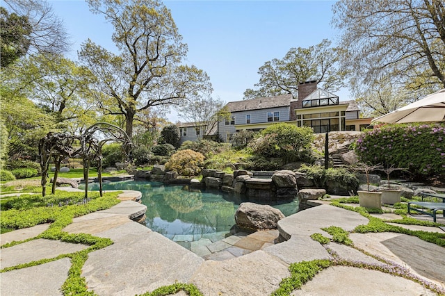 pool featuring a small pond