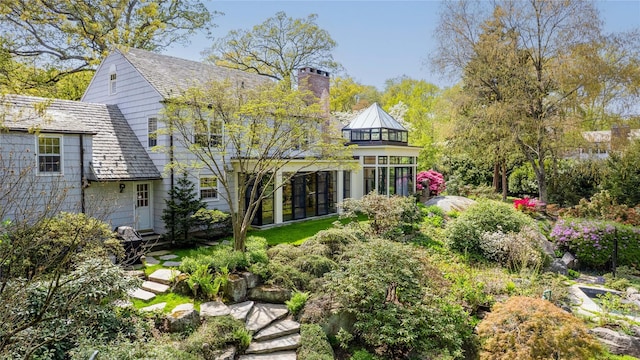 rear view of property featuring a chimney