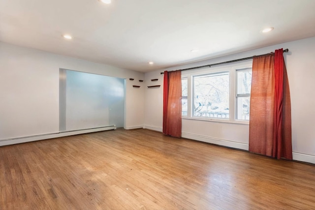 spare room with recessed lighting, a baseboard radiator, baseboard heating, and light wood finished floors
