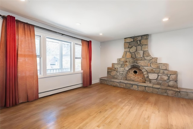 unfurnished living room featuring light wood-type flooring, recessed lighting, and baseboard heating