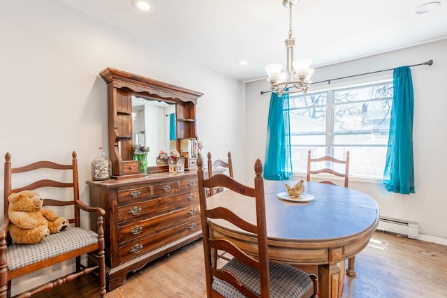 dining space with a baseboard heating unit, recessed lighting, light wood-style flooring, and a notable chandelier
