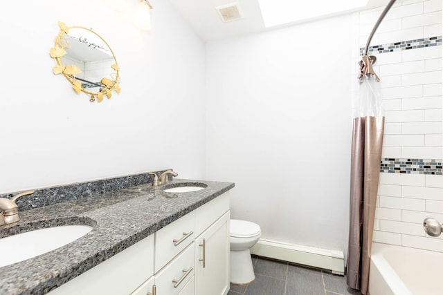bathroom featuring toilet, a sink, baseboard heating, and visible vents