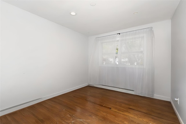 unfurnished room featuring recessed lighting, baseboards, baseboard heating, and wood finished floors
