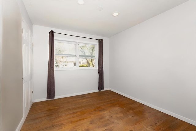 unfurnished room with recessed lighting, baseboards, and wood finished floors