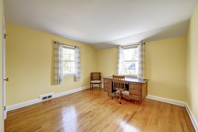 office area featuring plenty of natural light, visible vents, baseboards, and light wood-type flooring