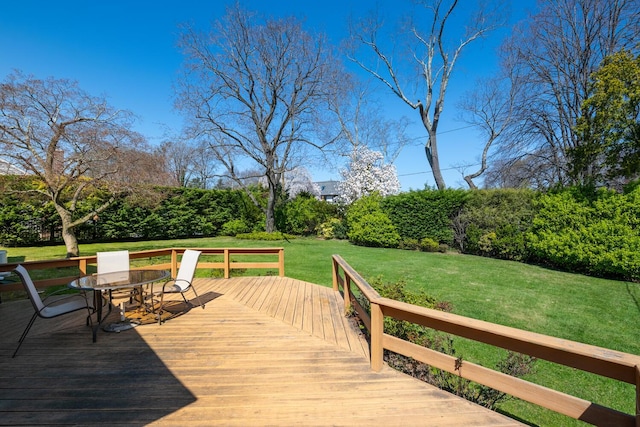 wooden deck with a lawn