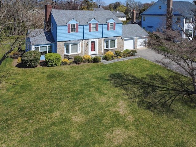 view of front of home with driveway, a chimney, stone siding, and a garage