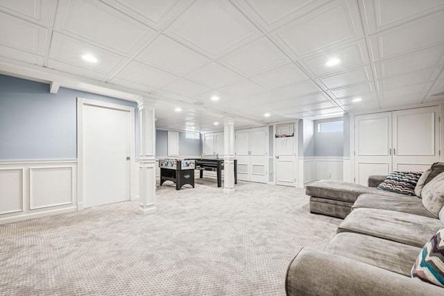 living room with light carpet, a decorative wall, and recessed lighting