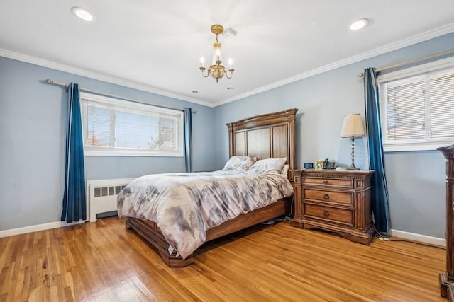 bedroom with an inviting chandelier, crown molding, baseboards, light wood finished floors, and radiator heating unit