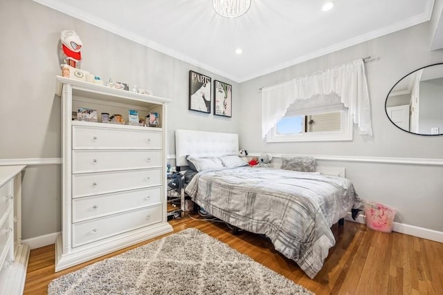 bedroom featuring crown molding, recessed lighting, baseboards, and wood finished floors
