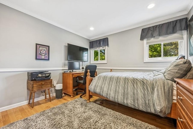 bedroom with crown molding, baseboards, recessed lighting, and wood finished floors