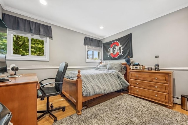 bedroom featuring a baseboard radiator, ornamental molding, recessed lighting, and wood finished floors