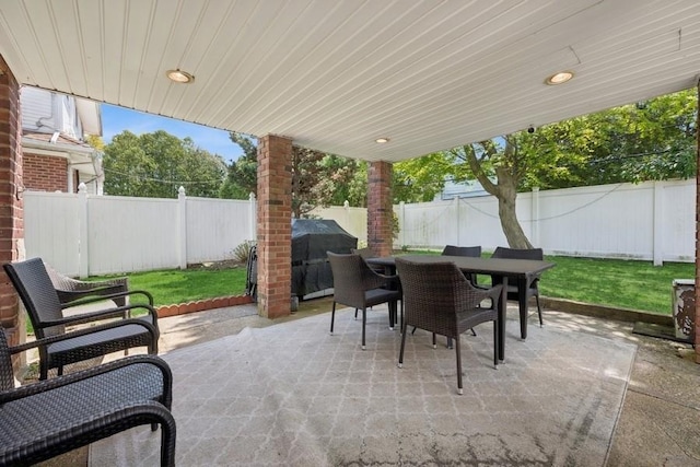 view of patio with a fenced backyard, grilling area, and outdoor dining space
