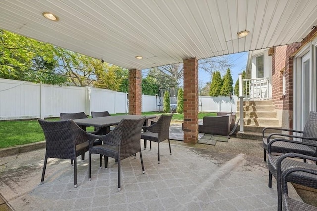 view of patio featuring a fenced backyard and outdoor dining space