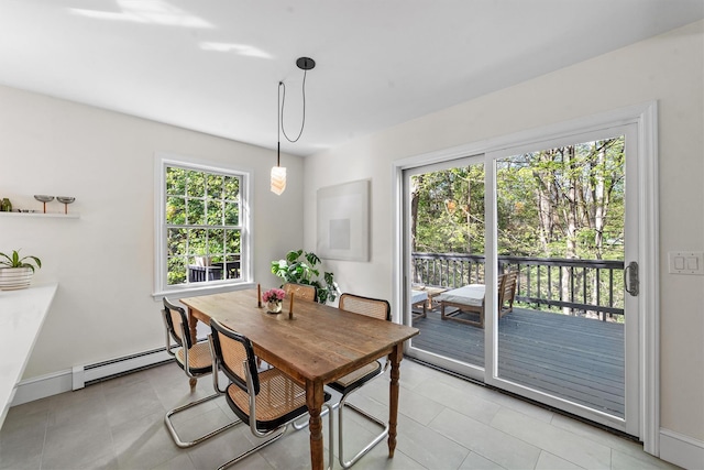 dining room featuring baseboards, a baseboard radiator, and light tile patterned flooring