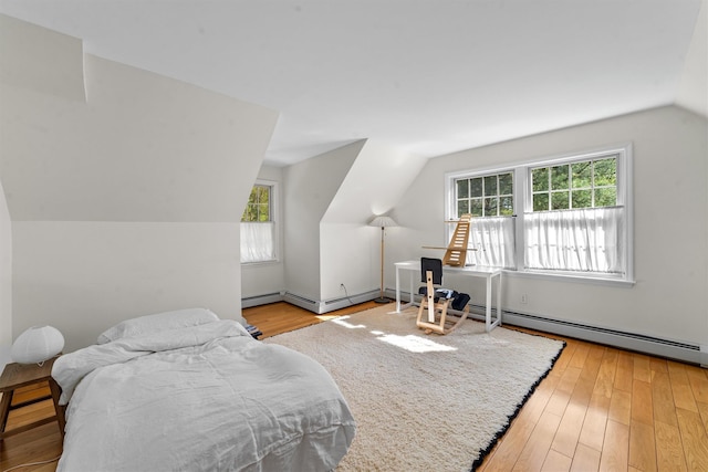bedroom with multiple windows, lofted ceiling, and hardwood / wood-style floors