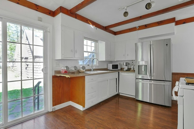 35 Harding St, Pearl River, NY 10965 - kitchen with white appliances, beamed ceiling, dark wood-style floors, white cabinetry, and a sink