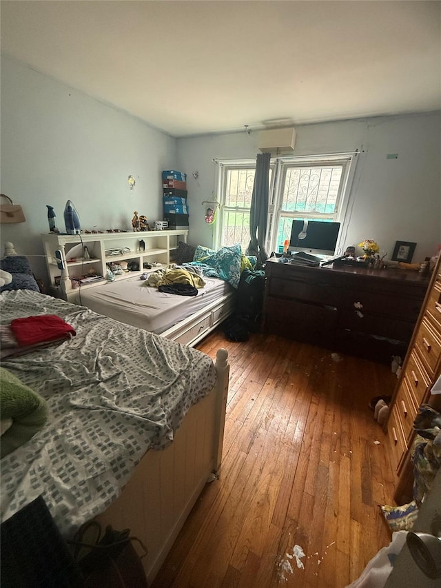 bedroom with hardwood / wood-style flooring