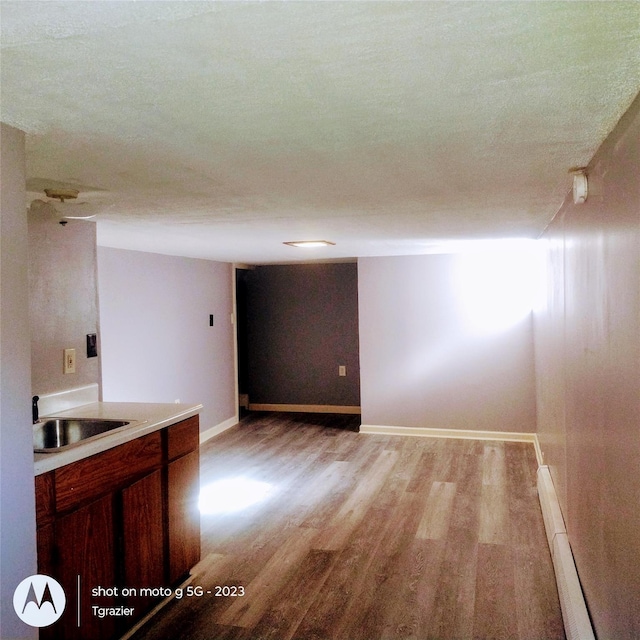 109 Lake Ave, Middletown, NY 10940 - unfurnished room with a sink, light wood finished floors, a baseboard heating unit, and baseboards