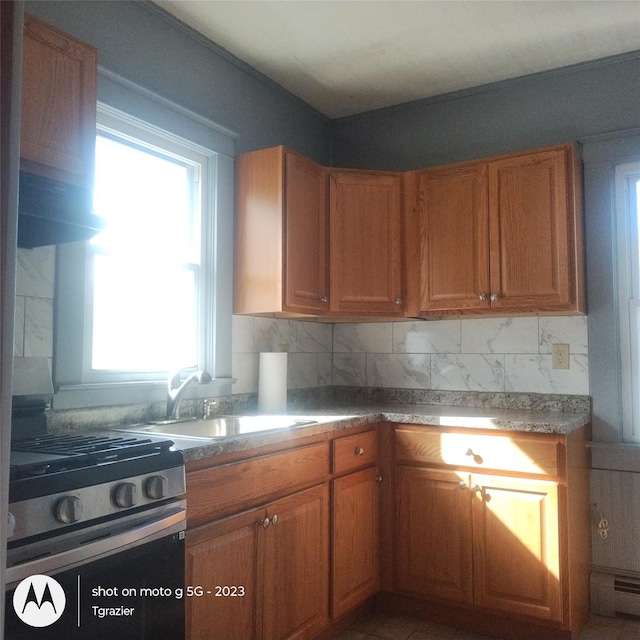 109 Lake Ave, Middletown, NY 10940 - kitchen featuring stainless steel gas range oven, a sink, backsplash, and brown cabinetry