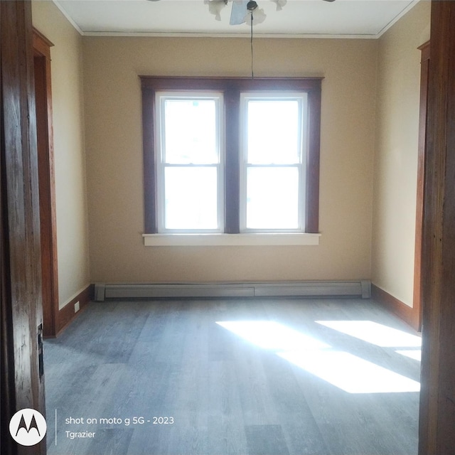 109 Lake Ave, Middletown, NY 10940 - unfurnished room with crown molding, wood finished floors, baseboard heating, baseboards, and a ceiling fan