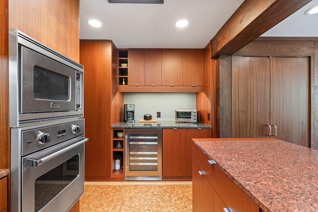 kitchen featuring open shelves, dark stone counters, brown cabinetry, appliances with stainless steel finishes, and wine cooler