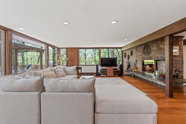 living room with wood finished floors, a fireplace, and recessed lighting