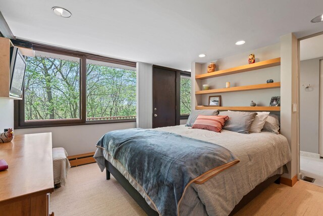 bedroom with baseboards, baseboard heating, and recessed lighting