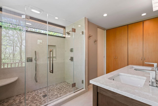 full bathroom with a sink, a stall shower, and recessed lighting
