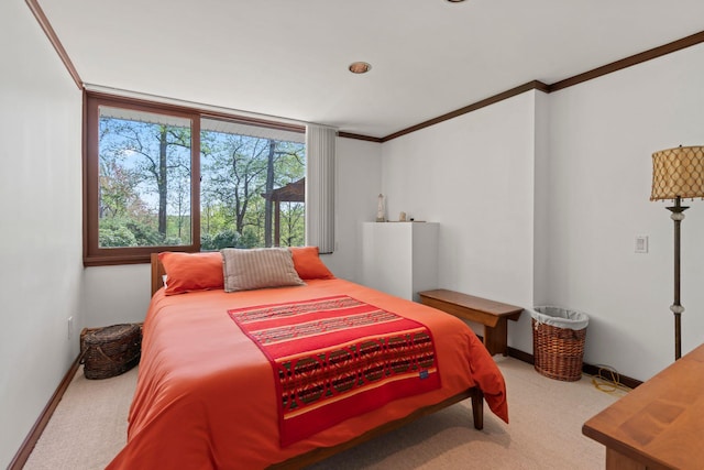 bedroom featuring ornamental molding, carpet flooring, and baseboards