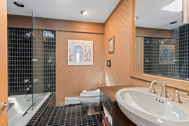 full bathroom with tile patterned flooring, toilet, tiled shower / bath, and vanity