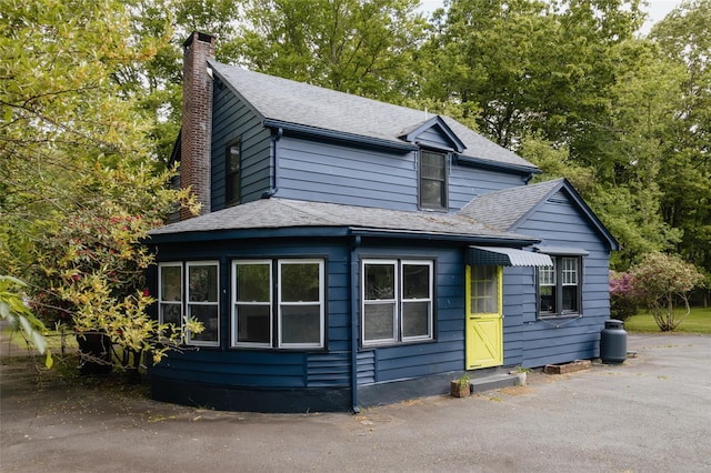 2383 State Route 97, Pond Eddy, NY 12770 - view of side of property with a chimney and roof with shingles