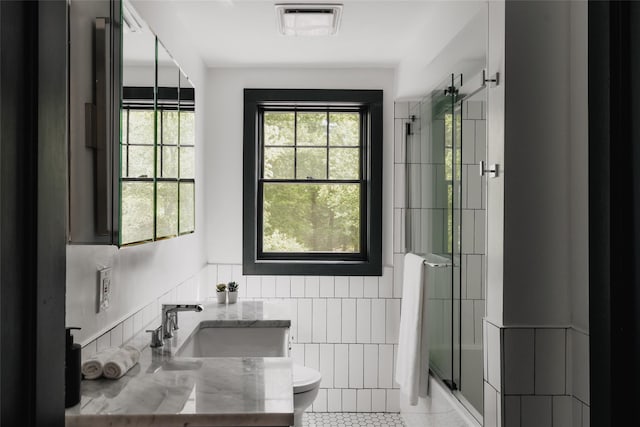 2383 State Route 97, Pond Eddy, NY 12770 - bathroom with toilet, tile walls, shower / bath combination with glass door, vanity, and tile patterned flooring