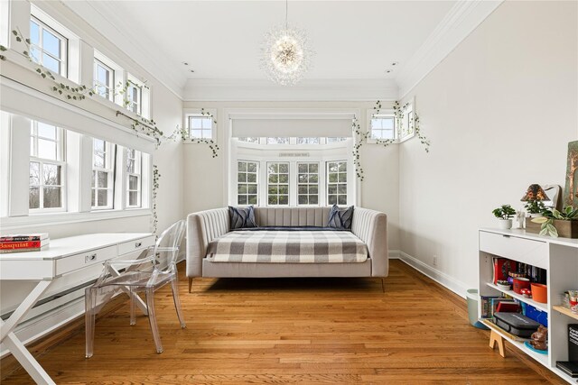 bedroom with crown molding, baseboards, a chandelier, and light wood-style floors