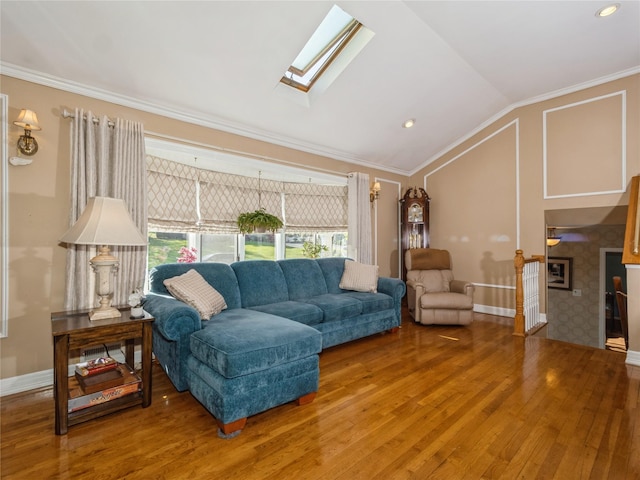 living area featuring crown molding, baseboards, wood finished floors, and lofted ceiling with skylight