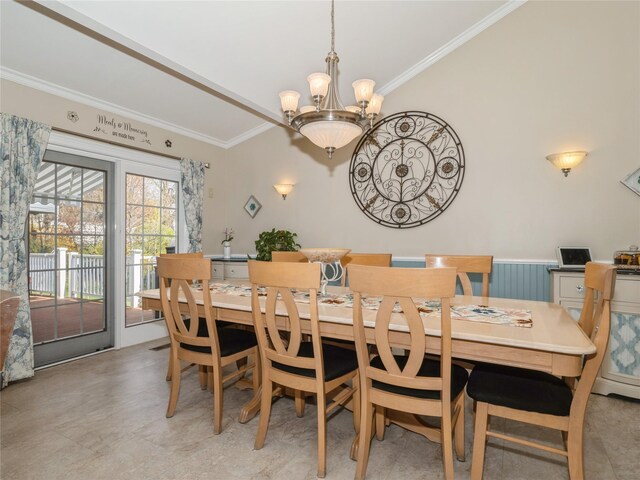 dining space with crown molding and a chandelier