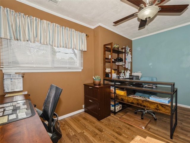 office area featuring ornamental molding, wood finished floors, baseboards, and ceiling fan