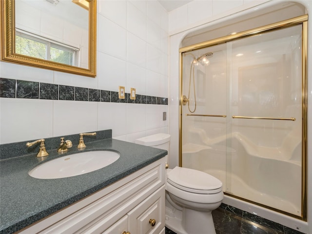 bathroom featuring a stall shower, tile walls, vanity, and toilet