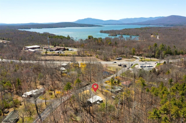 aerial view with a water and mountain view and a forest view