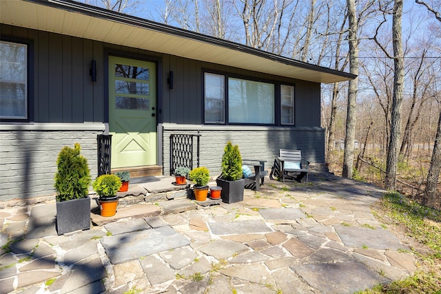 entrance to property featuring brick siding