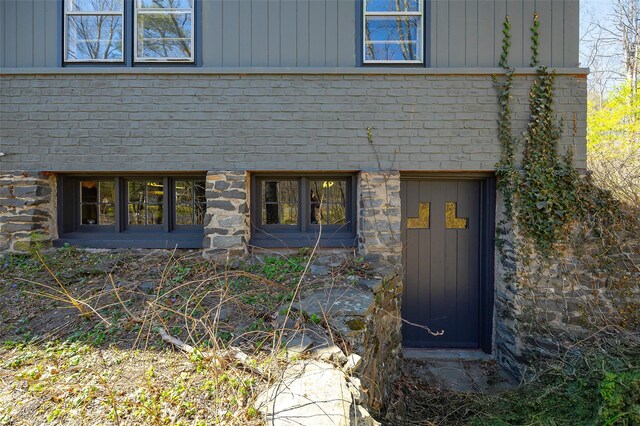 exterior space featuring stone siding and board and batten siding